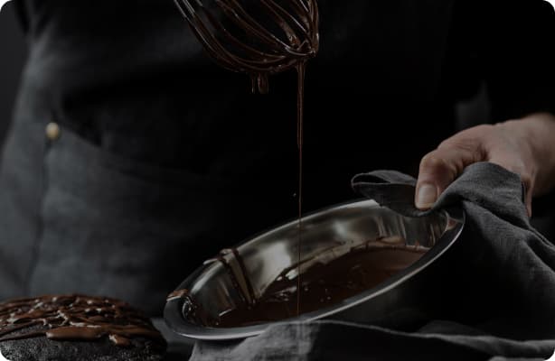 the picture of a pastry chef pouring chocolate
